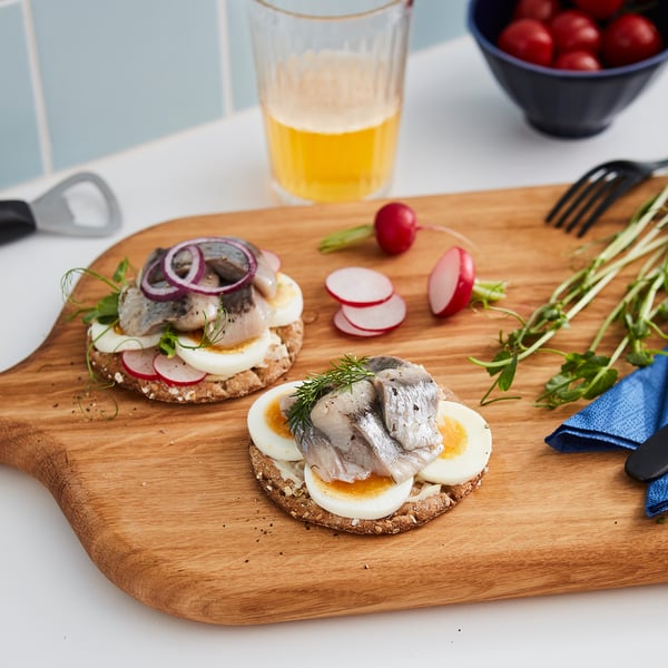 Rustic bread slices with toppings and beer.