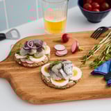 Rustic bread slices with toppings and beer.