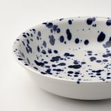 Blue & white speckled bowl, smooth edge, elegant design.