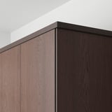 Close-up of dark wooden kitchen cabinet fronts with oak trim, showcasing modern design and craftsmanship.