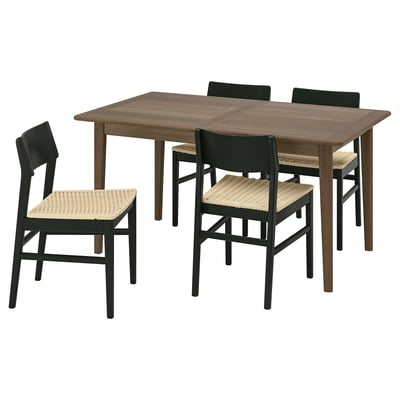 Modern dining set with brown wooden table and black chairs, featuring woven seats and sturdy legs.