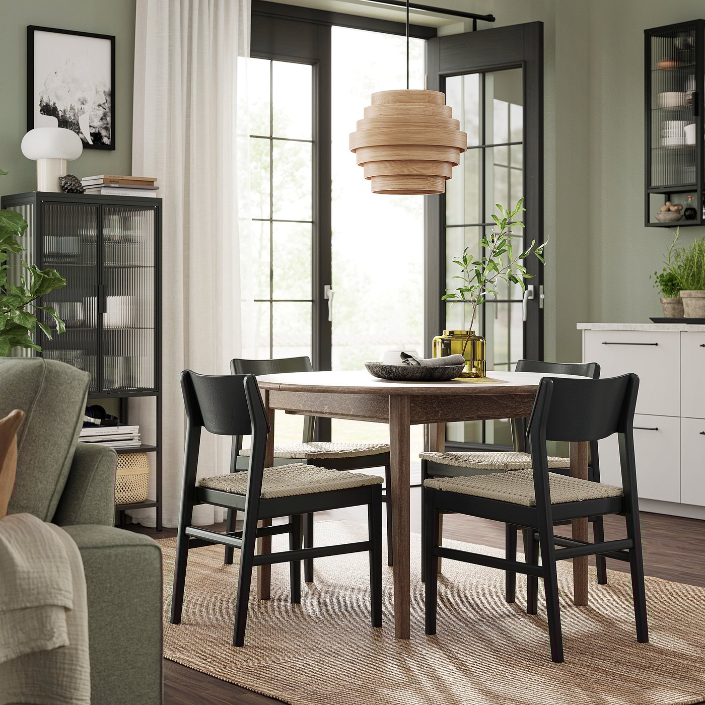 Modern dining set with extending table and black chairs. Rustic wood finish, round shape, natural accents, and sleek design.