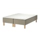 The skarer bed base a beige upholstered frame with wooden legs, holding a white mattress.