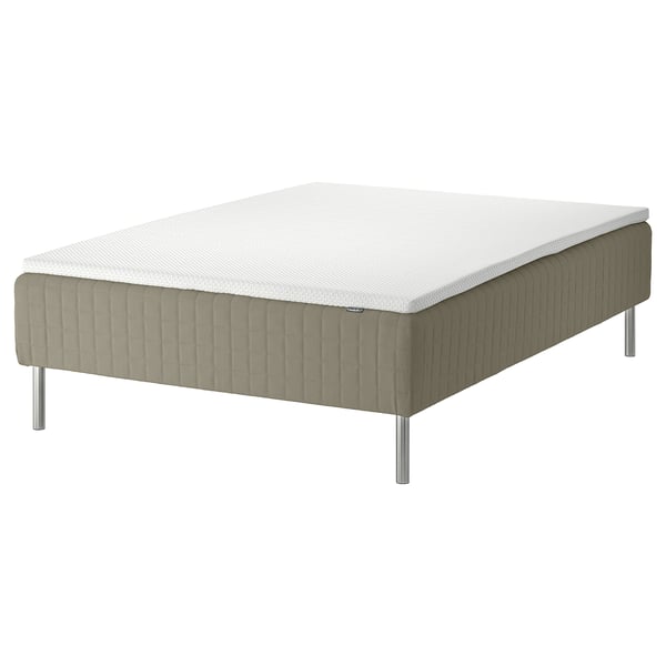 A minimalist, modern bed with grey fabric and stainless steel legs.