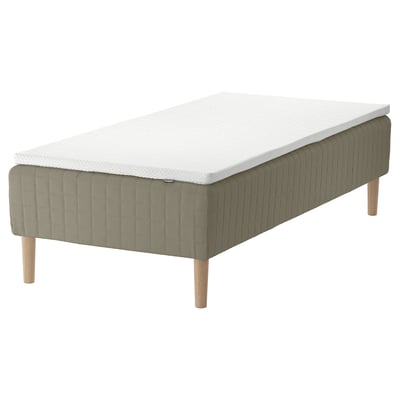 A SKÅRER bed in green and white. It has a wooden base with sprung mattresses for comfort, featuring light wooden legs.