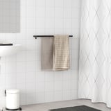 Black SKOGSVIKEN towel rail holds towels near white-tiled wall. Its slim, horizontal, fits between larger items.