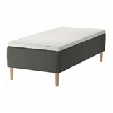 Grey foam pocket spring mattress with wooden legs.