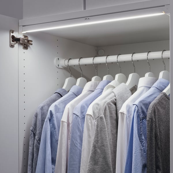 A wardrobe with hanging shirts lit by SKYDRAG led light strips.