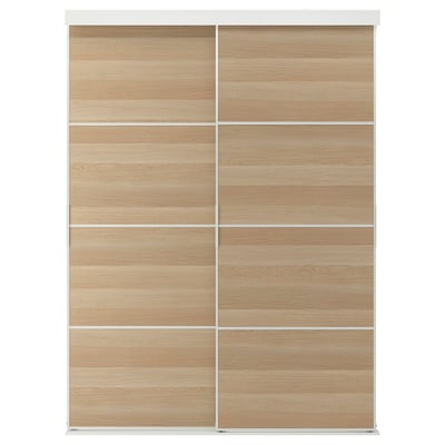 A SKYTTA light wooden wardrobe with sliding doors, framed in white.