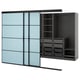 A blue SKYTTA sliding wardrobe with black interiors. It shelves, drawers, and a clothes rail.