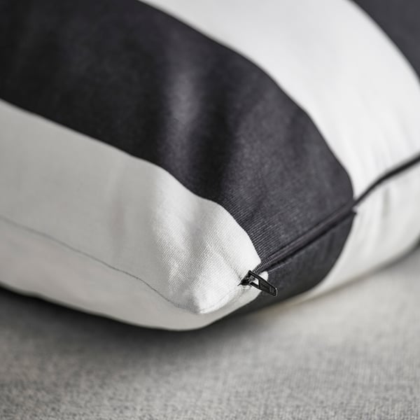 Modern cushion cover with black and white stripes, featuring a hidden zipper, made of high-quality, recycled cotton.