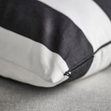 Modern cushion cover with black and white stripes, featuring a hidden zipper, made of high-quality, recycled cotton.