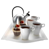 Clear plastic tray with four white coffee cups, a silver kettle, and two pastries, ideal for serving.