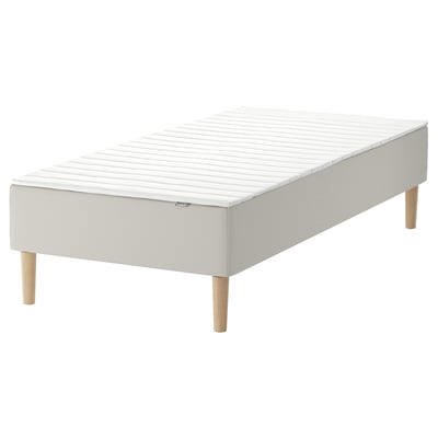 White ikea SNARUM bed with wooden legs.