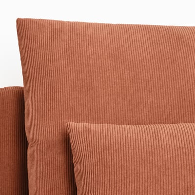 Brown corduroy sofa corner, textured and plush, inviting comfort.