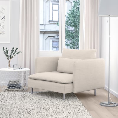 Modern beige SÖDERHAMN chair, sleek & cozy, fits snugly by large window.