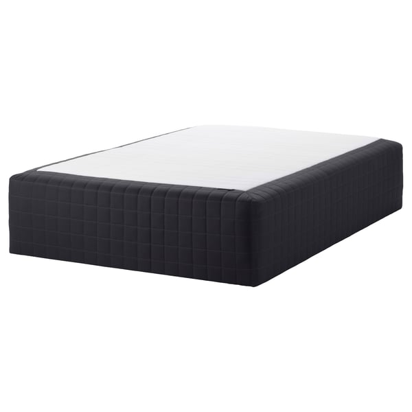 The STAVANGER bed mattress in black, featuring a textured cover and a supportive spring construction.