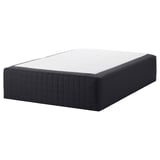The STAVANGER bed mattress in black, featuring a textured cover and a supportive spring construction.