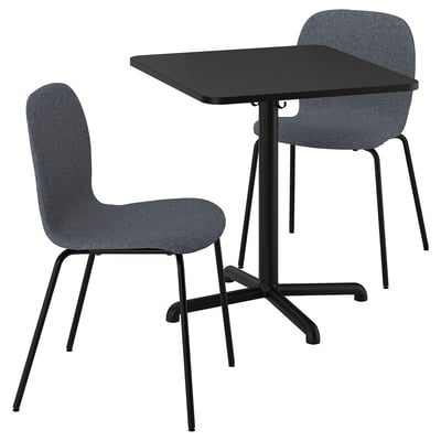 Modern black square dining table with two grey fabric chairs. Lightweight, with a sleek design featuring metal legs and adjustable feet.