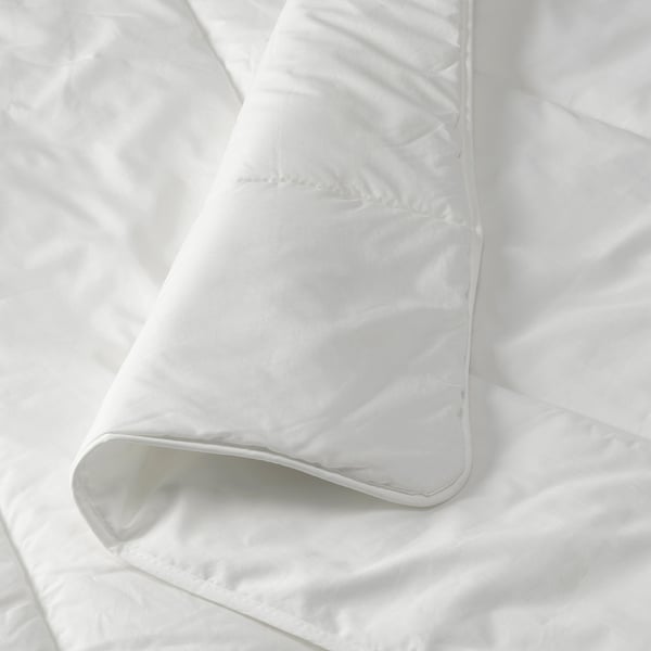 White duvet folded neatly, showcasing smooth, crisp fabric and precise stitching, highlighting its quality and craftsmanship.