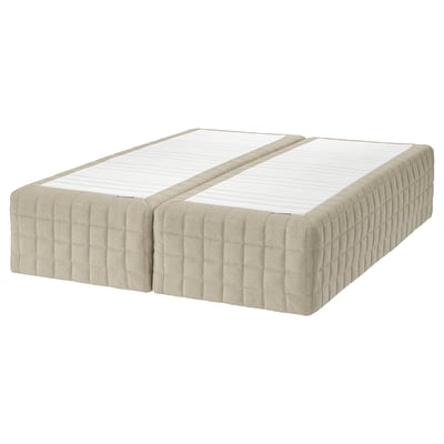 Two beige mattresses with a textured, quilted design lie side by side.