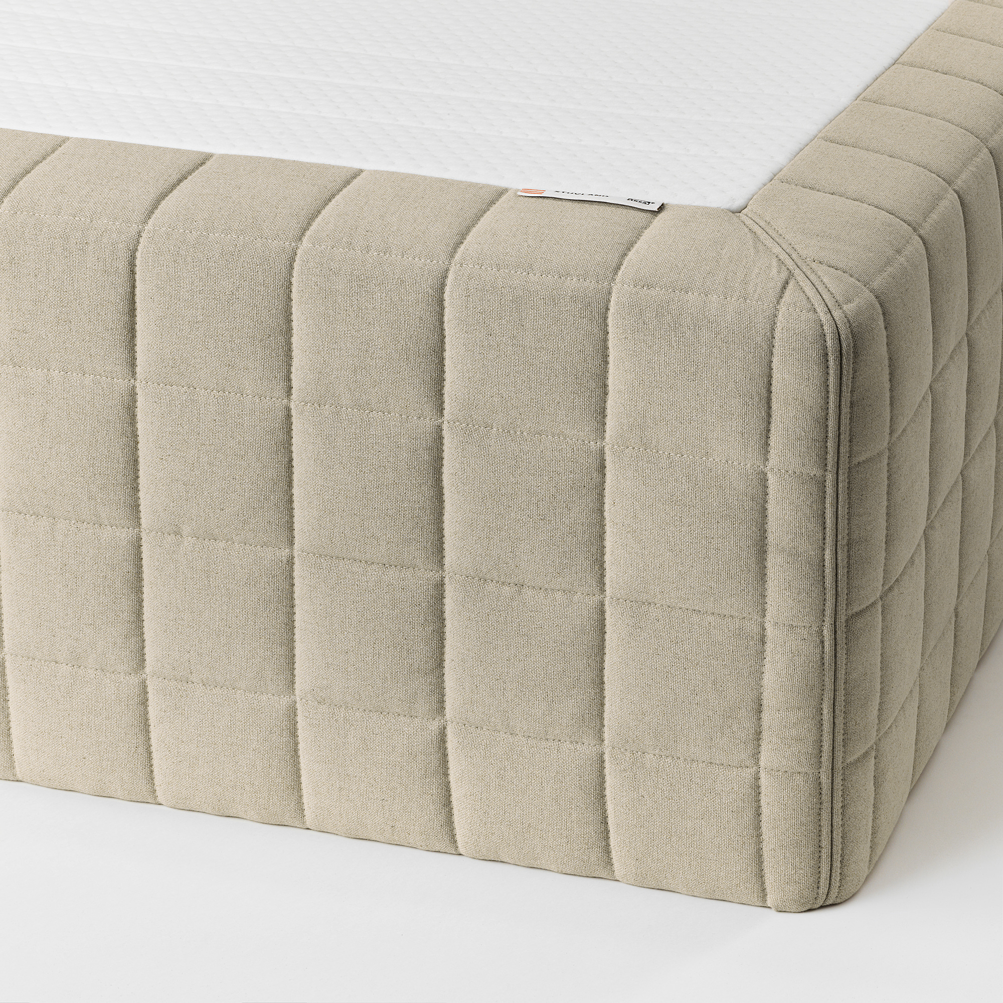 Close-up of stylish, textured mattress edge, highlighting premium materials and stitching detail.