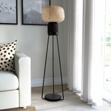 SYMFONISK wi-fi speaker lamp in black - modern, tall, bamboo shade, stands beside white couch, lit window nearby.