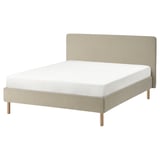 Minimalist bed, tan fabric, wooden legs, padded headboard, clean design.