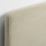 Close-up of modern bed frame with beige, ribbed fabric headboard; soft, comfy texture and clean stitching.