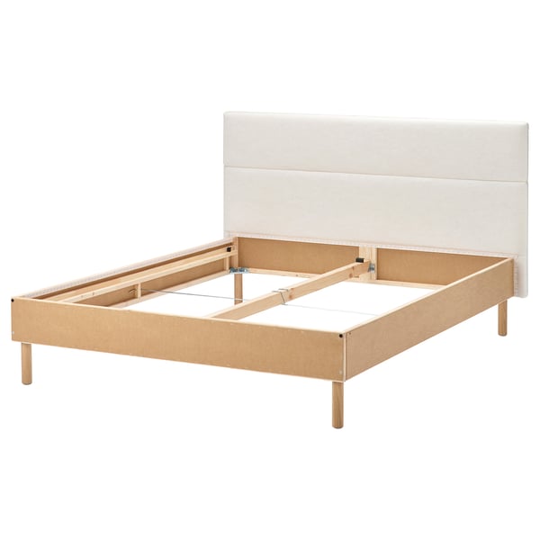 The TÄRNKULLEN bed a beige upholstered headboard and wooden frame. It’s lightweight and modern, with a square shape and basic design.