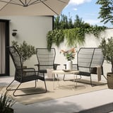 Modern patio set with black metal TALLSKÄR furniture: sofa, armchair, white coffee table. Steel and plastic wicker, ideal for outdoor relaxation.