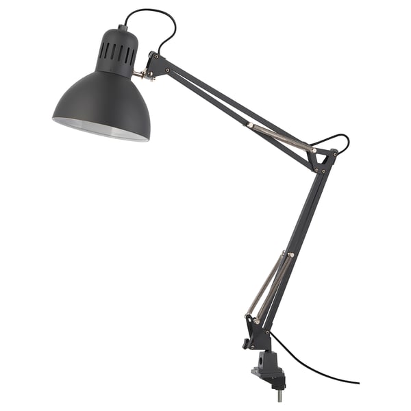 A TERTIAL adjustable gray desk lamp with a metallic finish and a wide adjustable arm.