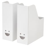 Two white TJABBA magazine files, made from 100% recycled cardboard, with cheerful faces. Upright, rectangular with a slanted top.