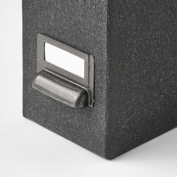 Black magazine file with textured surface and sturdy handle, designed for organizing papers and magazines.