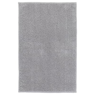 A grey TOFTBO bath mat, rectangular, with a soft, textured design. It is made from recycled polyester.