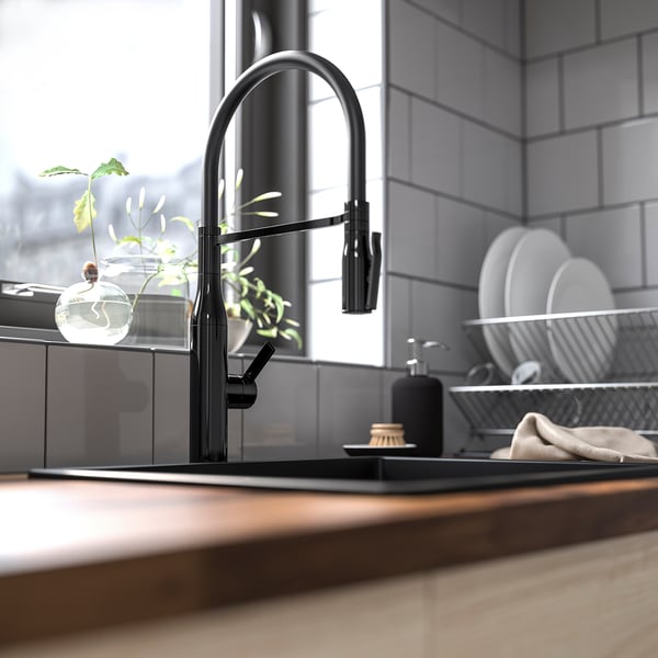 Modern TOLLSJÖN black kitchen faucet with sleek curve. Brass with metallized finish, detachable handspray, and dual-function feature.