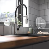 Modern kitchen with TOLLSJÖN chrome faucet, sleek and minimalist, near window.