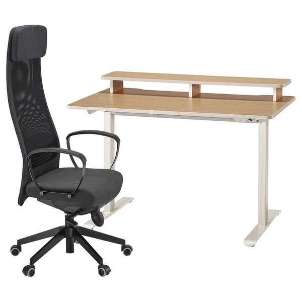The TRAVSPORT setup: a black ergonomic office chair and an adjustable wooden desk.
