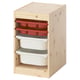 A TROFAST light wood storage unit with red and white plastic bins and trays for organizing childrens items.