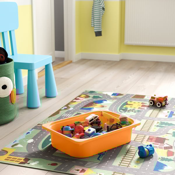 Colorful playroom with toy rug, vehicles, and orange bin for kids toys.