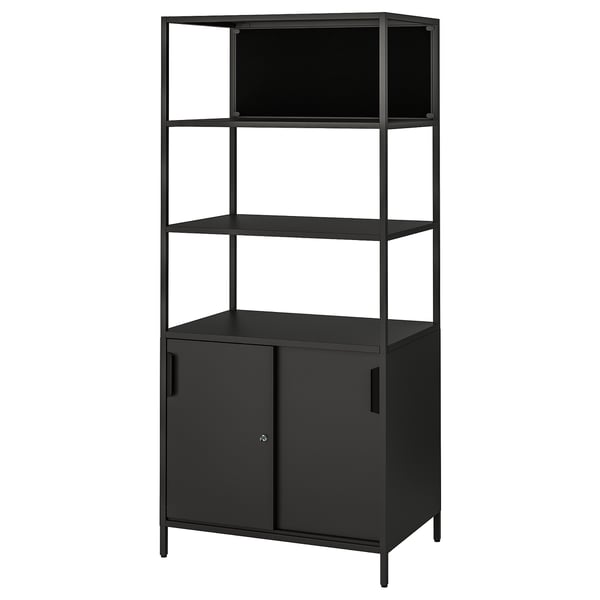 Black metal TROTTEN shelf unit with enclosed cabinet at base, three open shelves above. Modern, minimalist design.