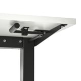 Close-up of a sturdy, height-adjustable standing desk mechanism with crank handle and metal frame.