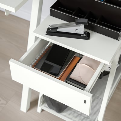 Drawer of trotton storage is open, revealing a wallet and papers inside.