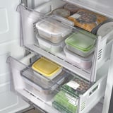 Fridge freezer with clear drawers and trays, showcasing organized food storage, quick freeze, and no frost functions.