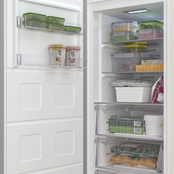 Open freezer with cheerful food containers. Includes TYNNERÅS no frost, quick freeze, and led light.