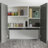 Kitchen cabinet with spice jars and containers, including hidden extractor hood.