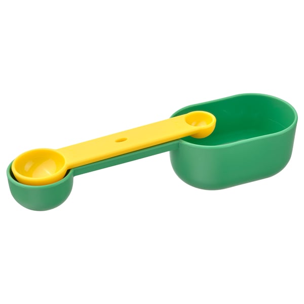 A kitchen measuring tool called UPPFYLLD, featuring green and yellow plastic spoons attached to a green handle.