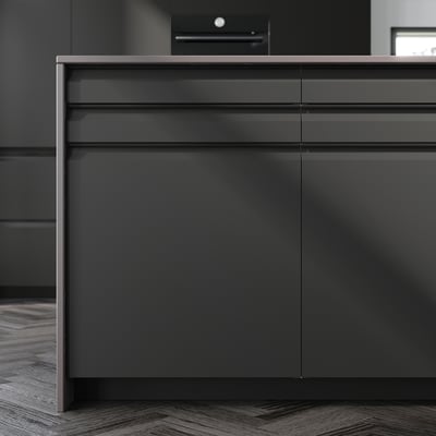 Modern gray kitchen cabinets with sleek, black integrated handles and chamfered edges.