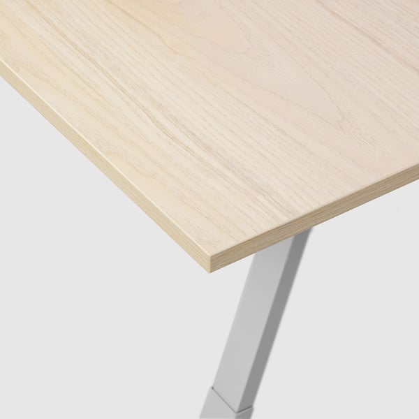 Clean, modern desk with smooth wooden top and sturdy metal legs, shown at an angle.