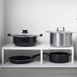 Two shelf inserts: one with black cookware, other with large/small pots.
